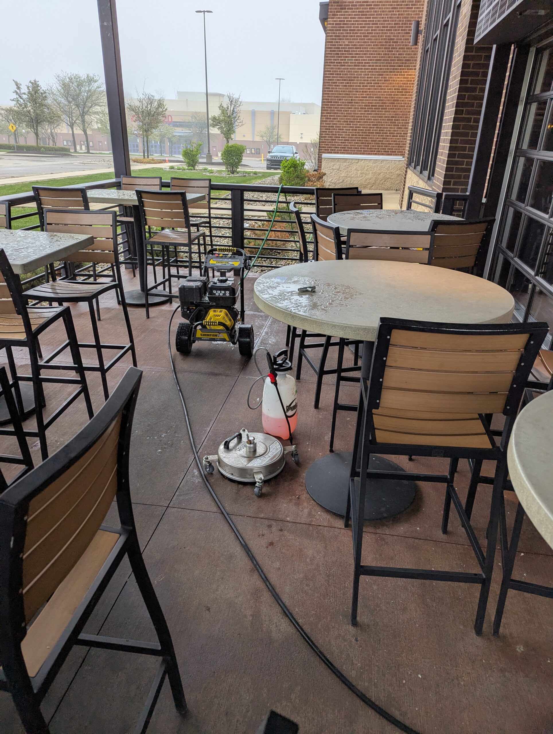 Pressure-washing equipment staged on a paved patio