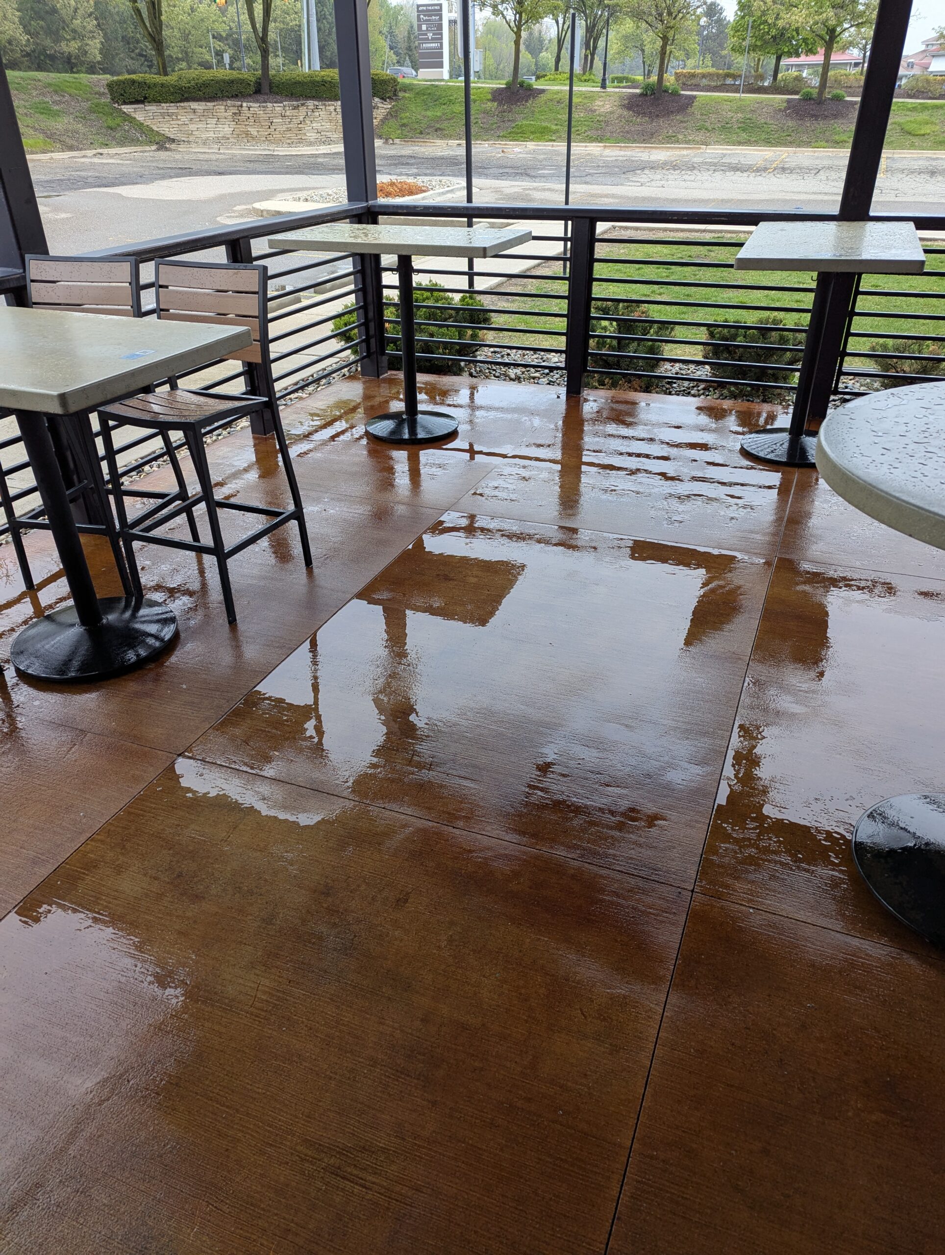 Wet paved patio during WashAway pressure washing