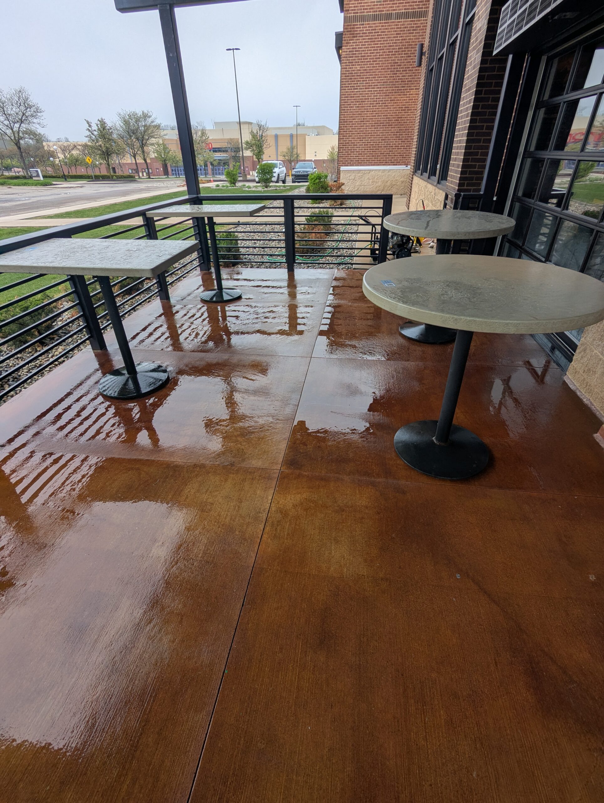 Wet paved patio during WashAway pressure washing