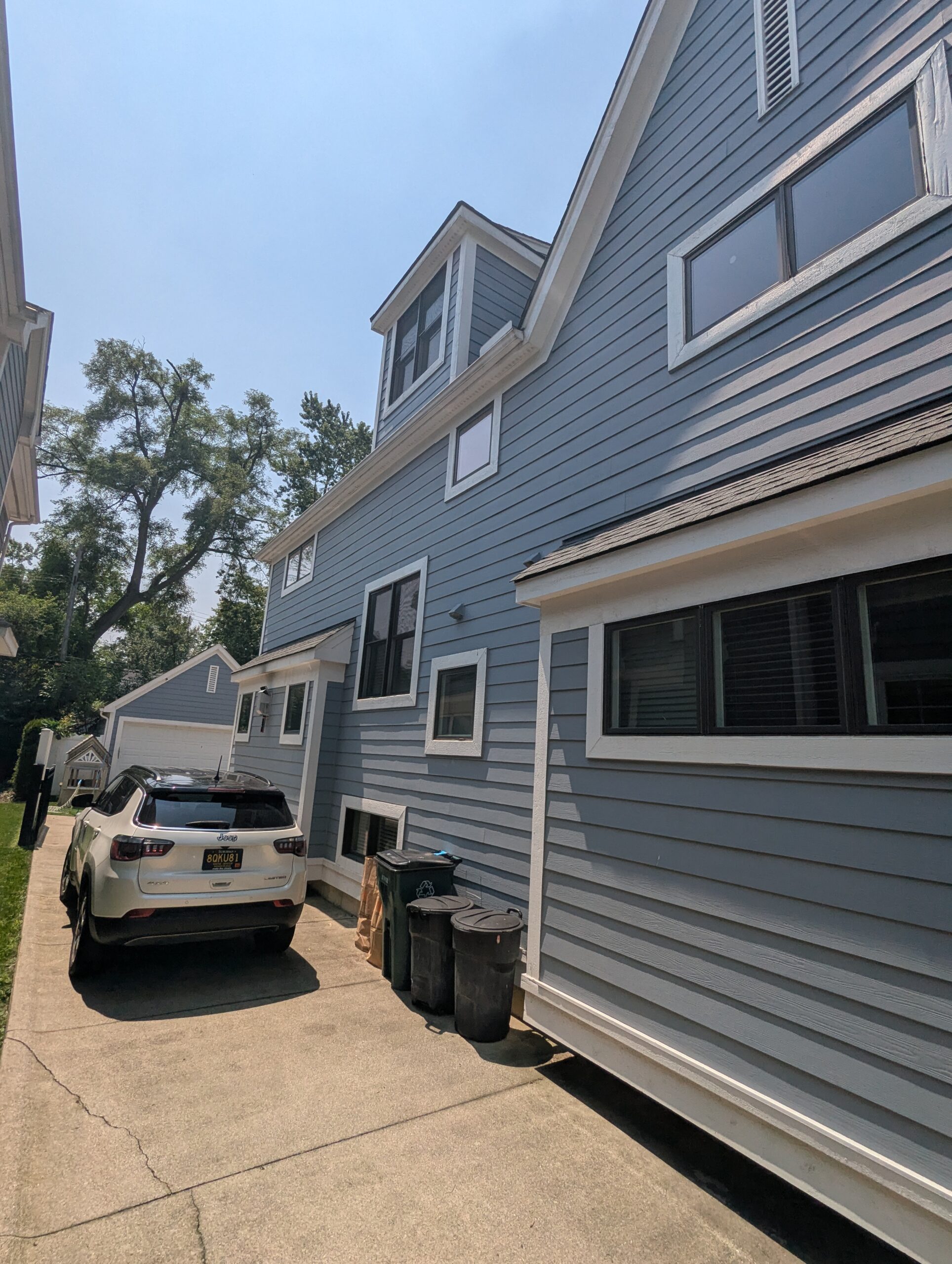 Residential home side exterior with multiple windows