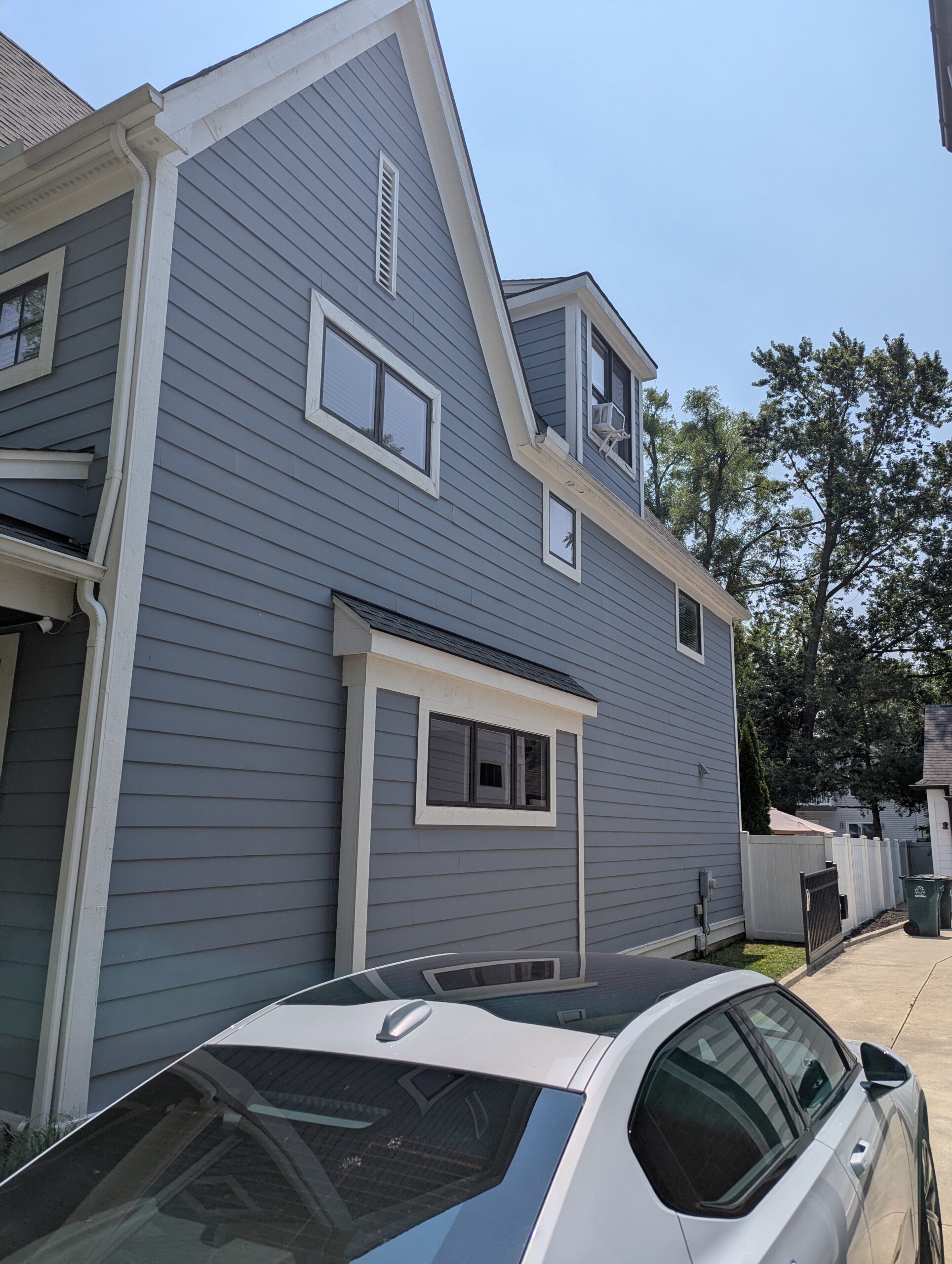 Residential home side exterior with multiple windows